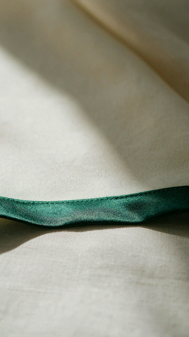 A close-up shows the perfectly finished hem of a well-made dress.