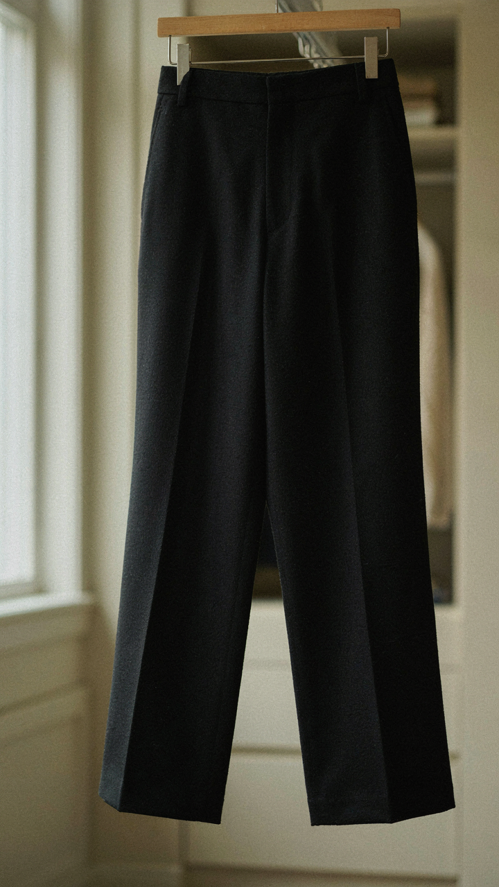 Impeccably tailored black wide leg pants made of heavy worsted wool.