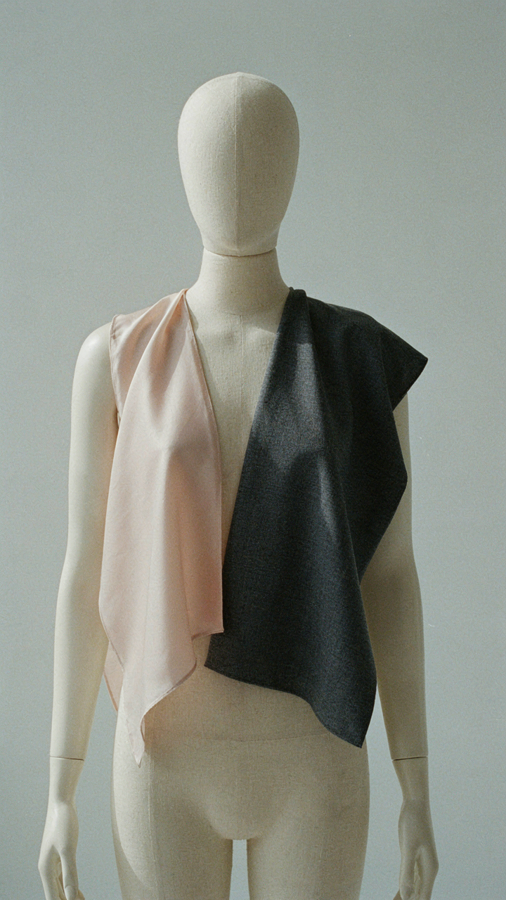 Silk charmeuse drapes softly next to a structured wool crepe swatch.