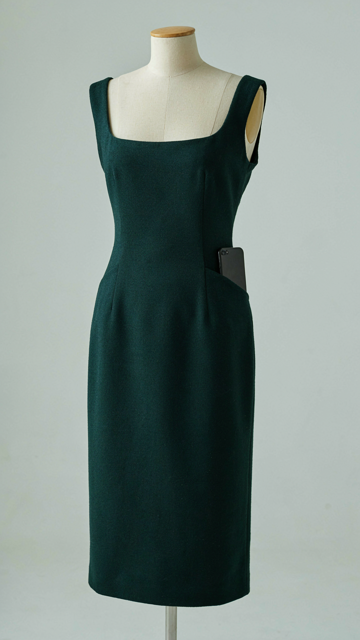 Midi dress on a mannequin with a phone half-inserted into a hidden side seam pocket.