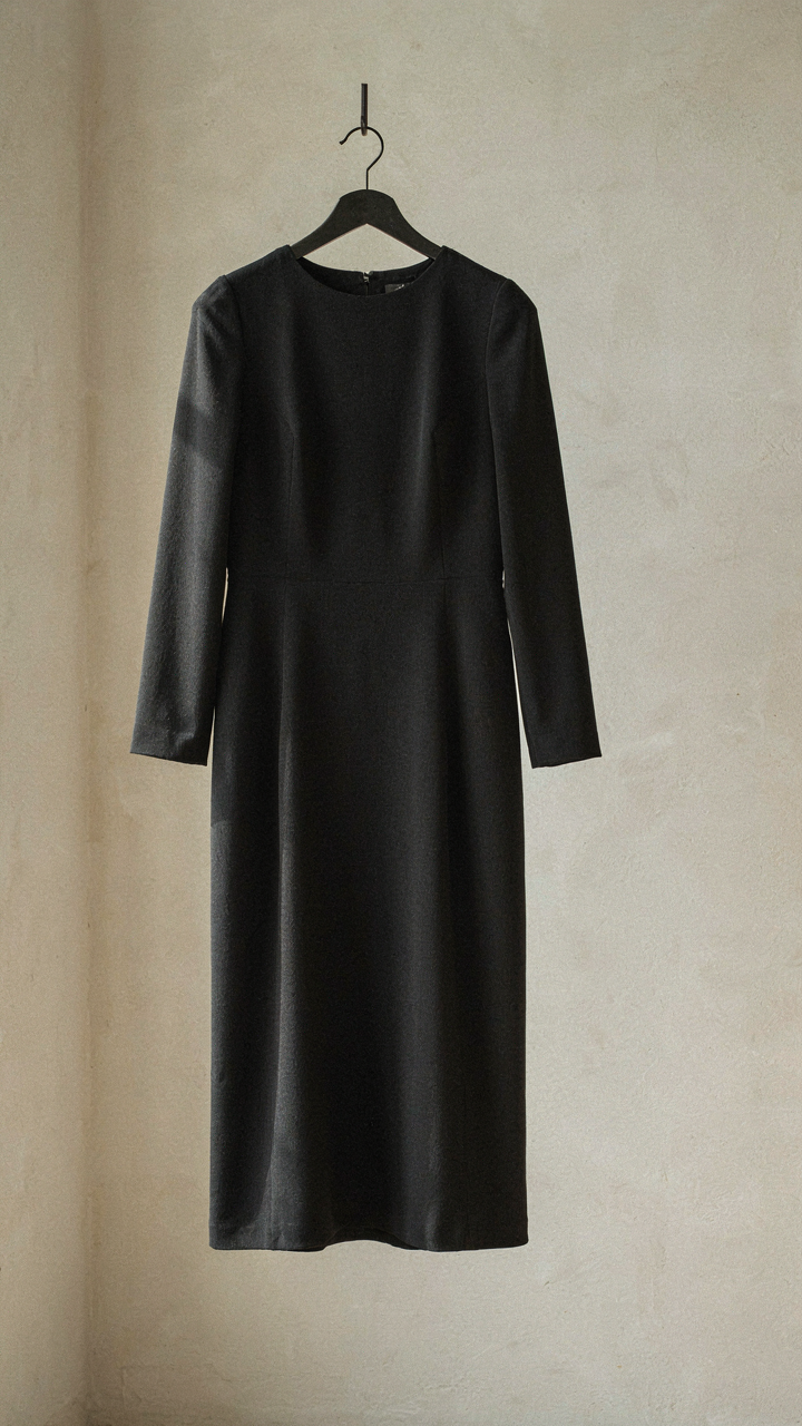 A precisely tailored long sleeve dress in a solid dark gray crepe.