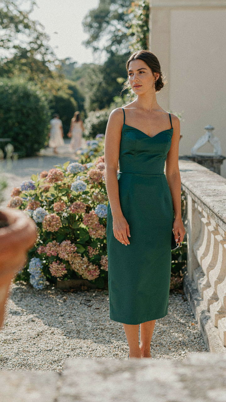 Woman with perfect posture in an elegant curvy wedding guest outfit.