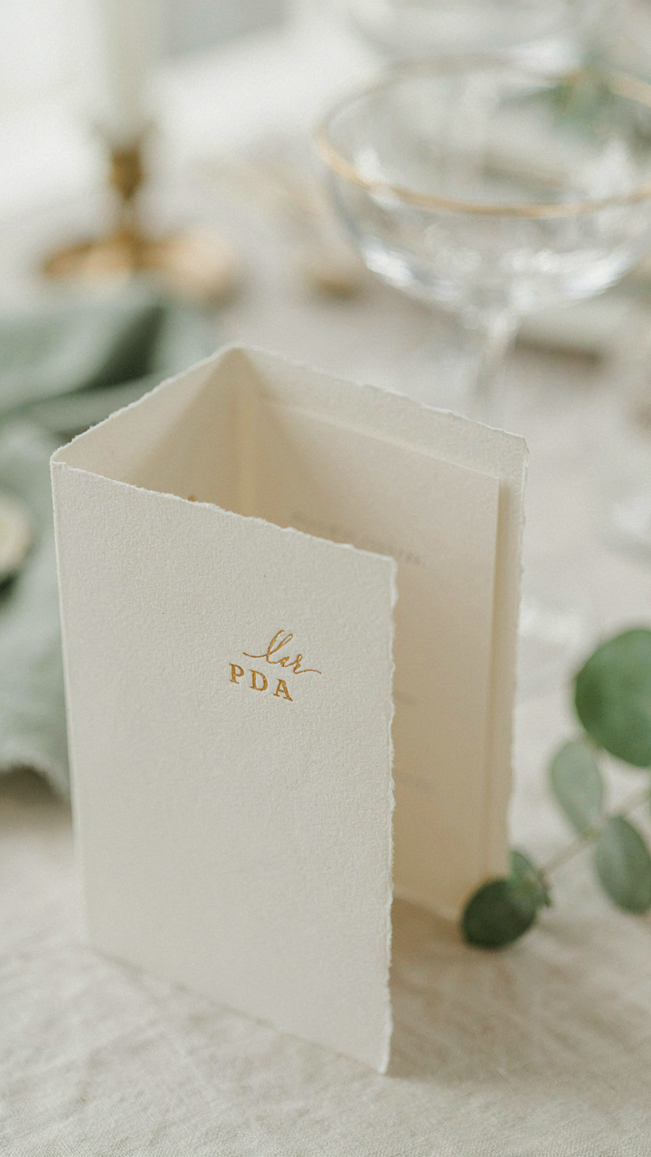 A close-up of an invitation card showing the words 'black tie optional'.