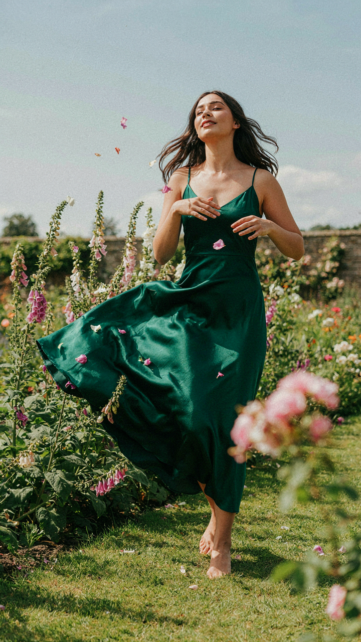 A long silk dress billows dramatically in a sudden gust of wind.