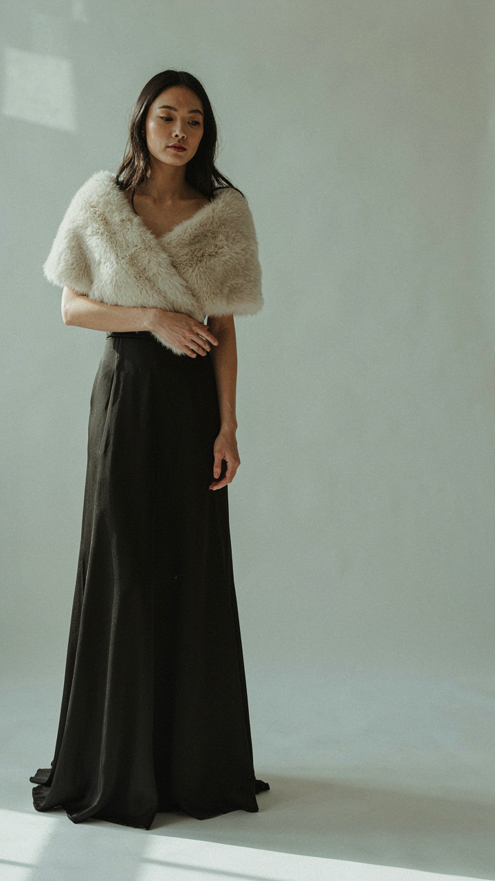 A sleek faux fur wrap evening piece matching a formal black tie gown.