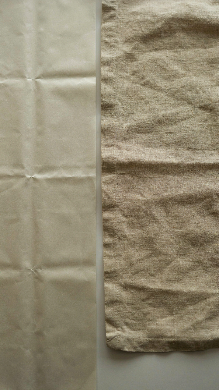 Wrinkle-resistant cotton fabric next to a naturally wrinkled linen swatch.