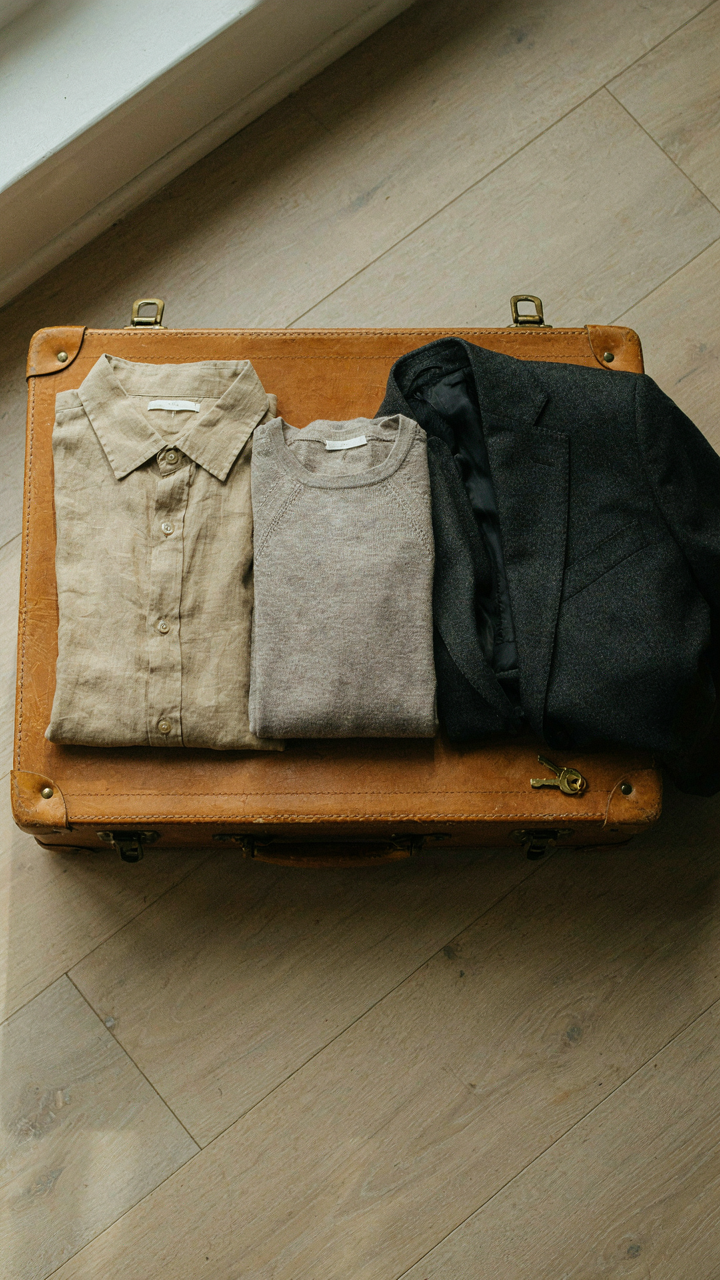 Merino base layer, linen overshirt, and wool blazer folded for travel.