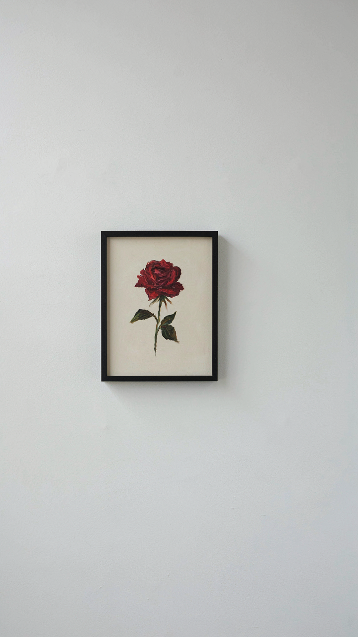 A minimalist painting of a single red rose is framed on a white wall.