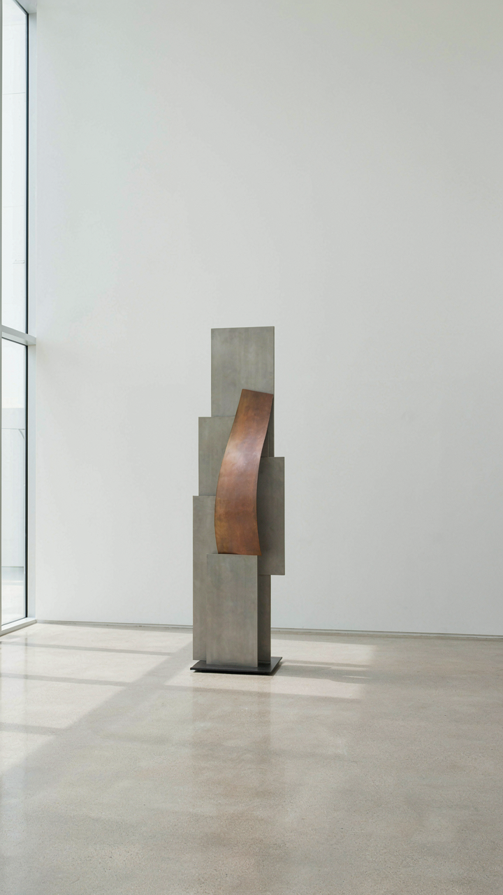 A minimalist art gallery with one striking abstract sculpture as a focal point.