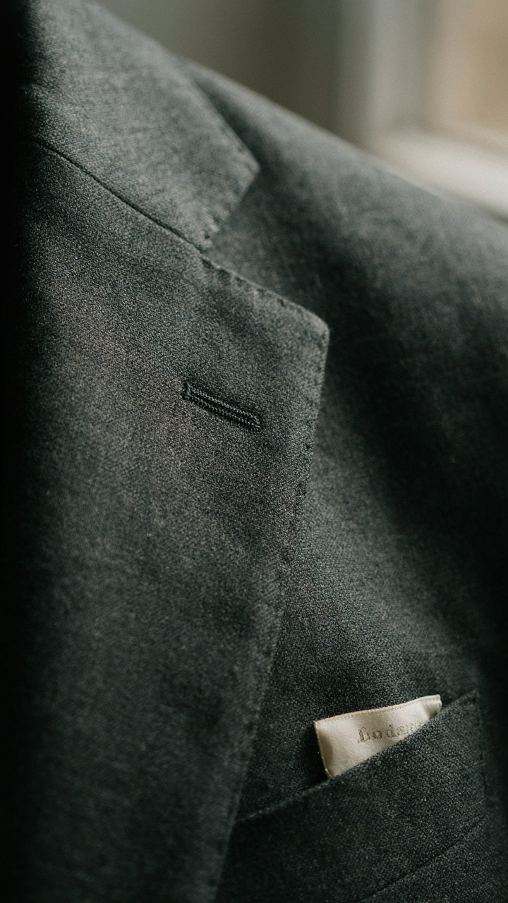 Close-up of a high-quality wool blazer fabric and label.