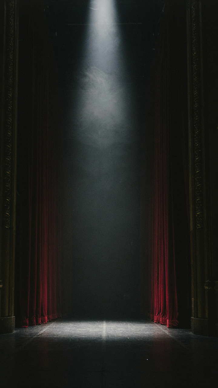 A single spotlight illuminates a stage, showing how light creates contrast.