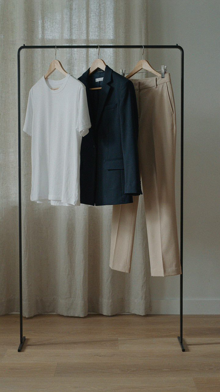 A capsule wardrobe with a fitted tee, blazer, and high-waisted trousers.