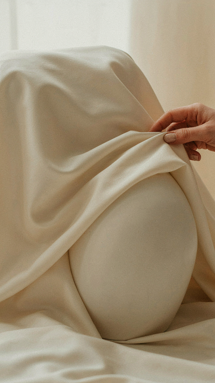 Close-up of silk fabric draping naturally over a curved surface.