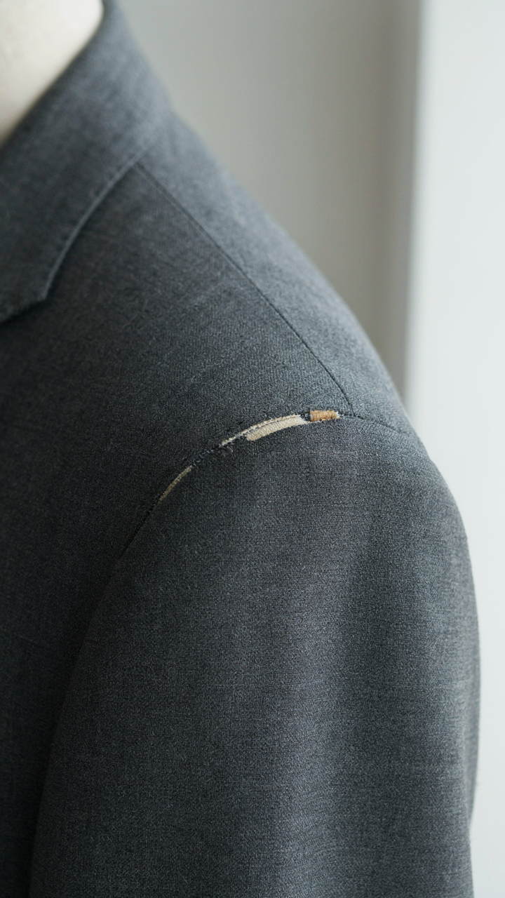 Close-up of a perfectly aligned shoulder seam on a structured blazer.