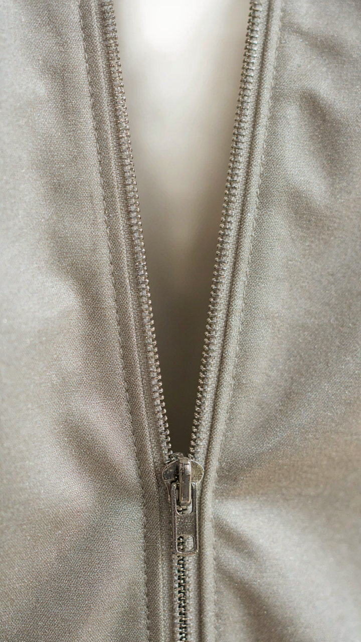 Close-up of internal stitching on a premium metallic cocktail dress.