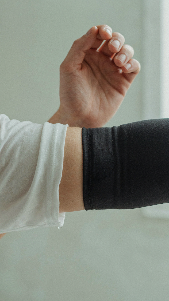 One arm with wet cotton, the other with dry, wicking synthetic fabric in hot weather.
