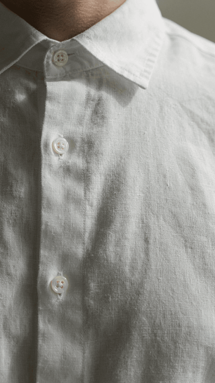 A man's crisp linen shirt shows no wrinkles after hours of wear.