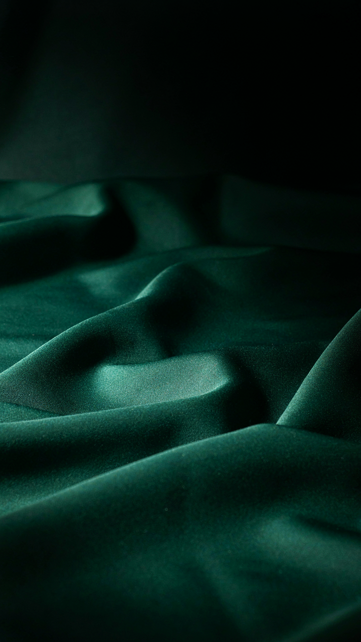 Folded satin fabric in a jewel tone reflects light dramatically.