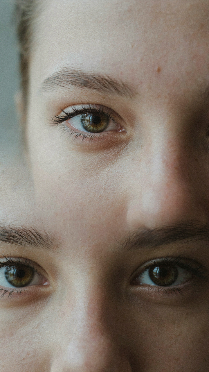 A person's eyes stare directly into the camera lens with intent.
