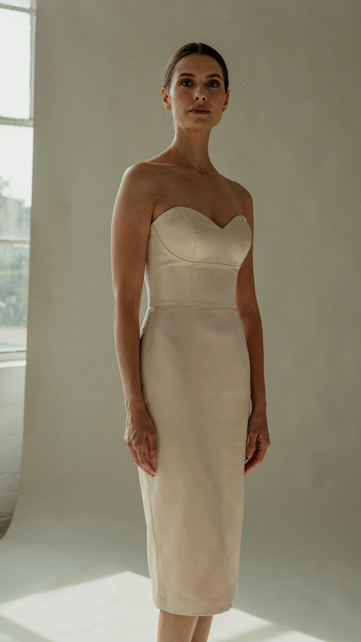 Woman in an elegant, simple sweetheart neckline dress made of satin.