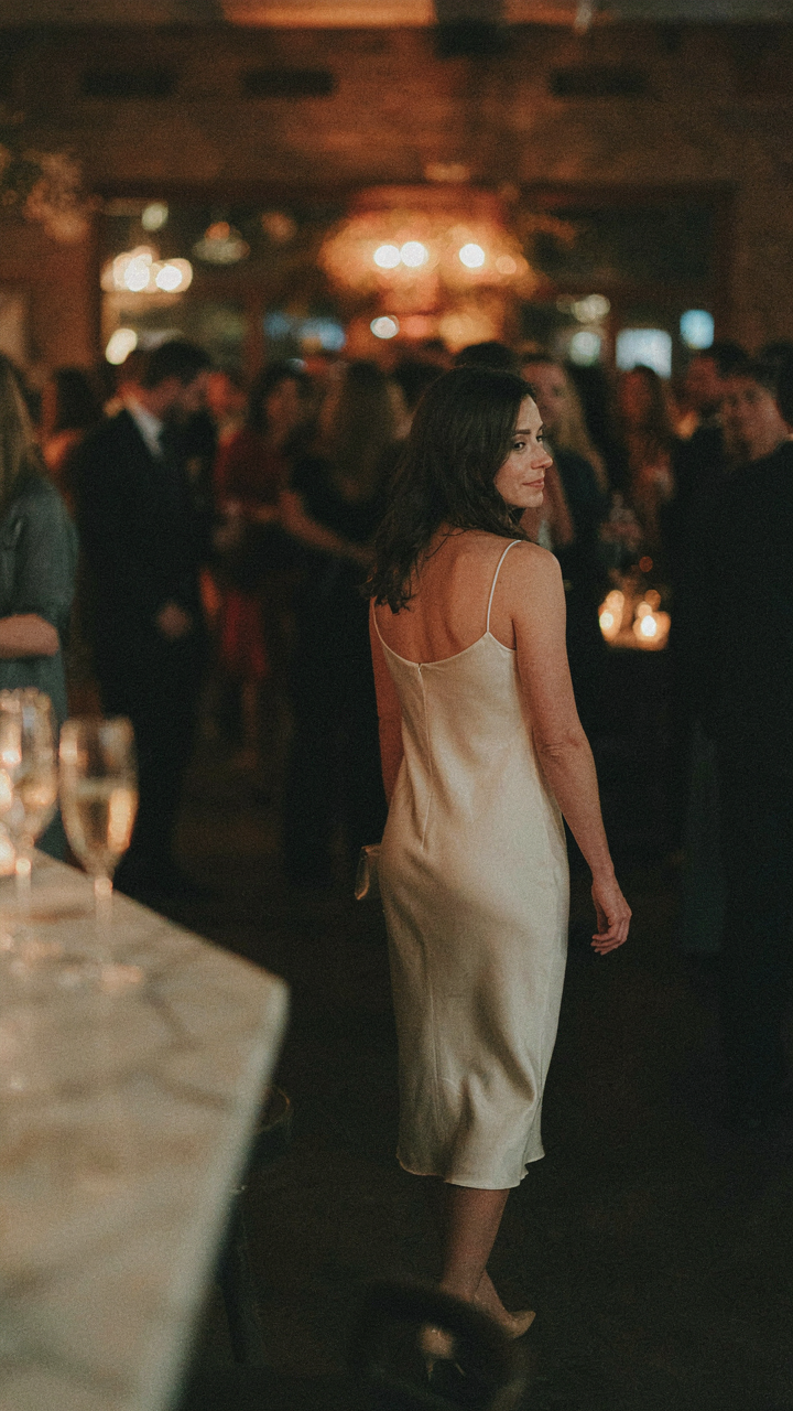A woman confidently walks away, wearing a well-suited retirement party outfit.