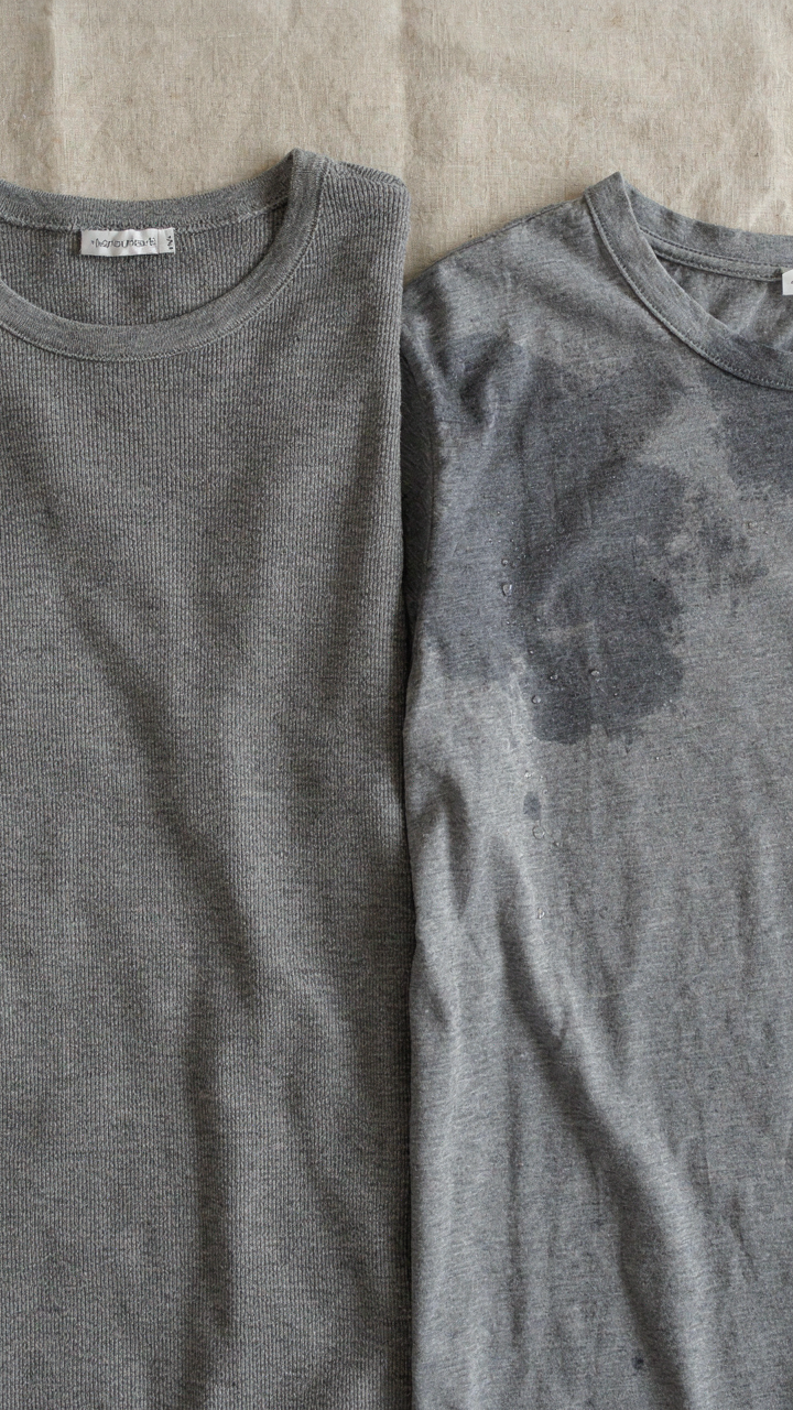 A soft merino wool undershirt lies next to a damp cotton shirt, highlighting fabric choice.