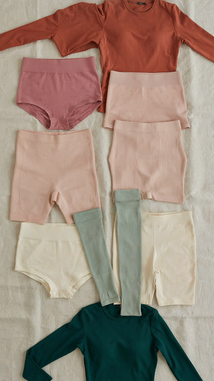 A display of various plus size shapewear garments in different lengths.