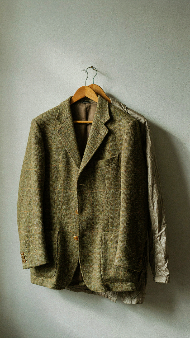 A structured tweed jacket next to a limp, wrinkled synthetic jacket.
