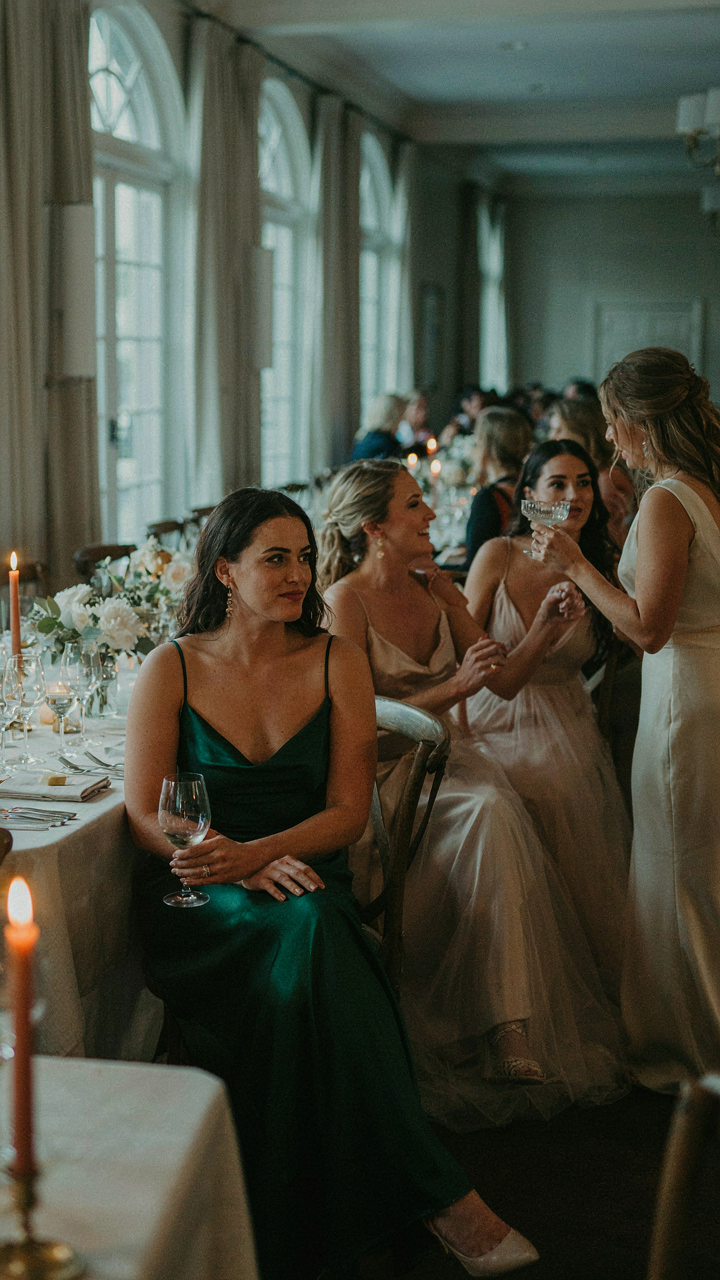 A woman discreetly watches other women's outfits at a formal country club dinner.