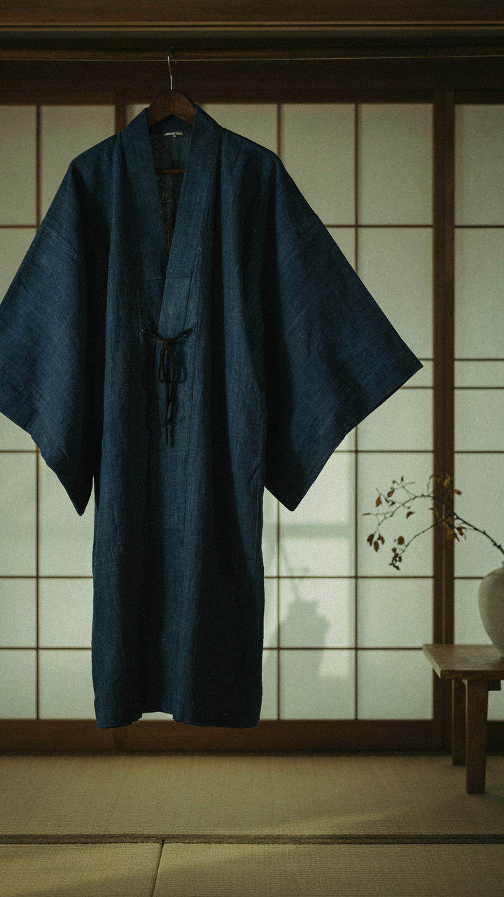 A beautifully crafted indigo-dyed silk kimono jacket hanging in a quiet room.