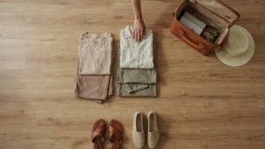 A carefully packed tropical vacation capsule wardrobe laid out on a bed.