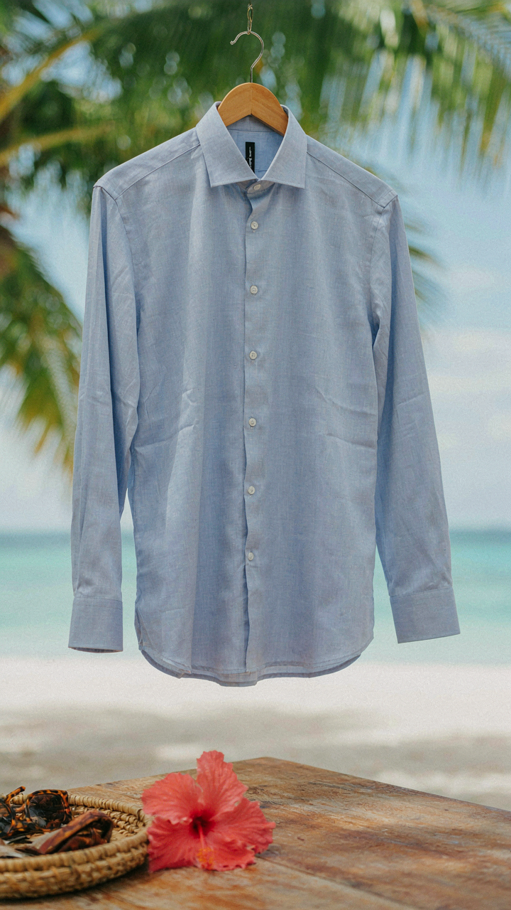 A tailored light blue linen shirt, showing intentional wrinkles.