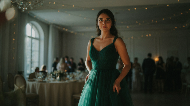 A woman wears a beautiful tulle cocktail dress at a fancy party.