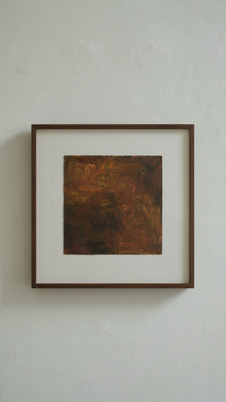 A textured painting is precisely framed by a wide white mat.