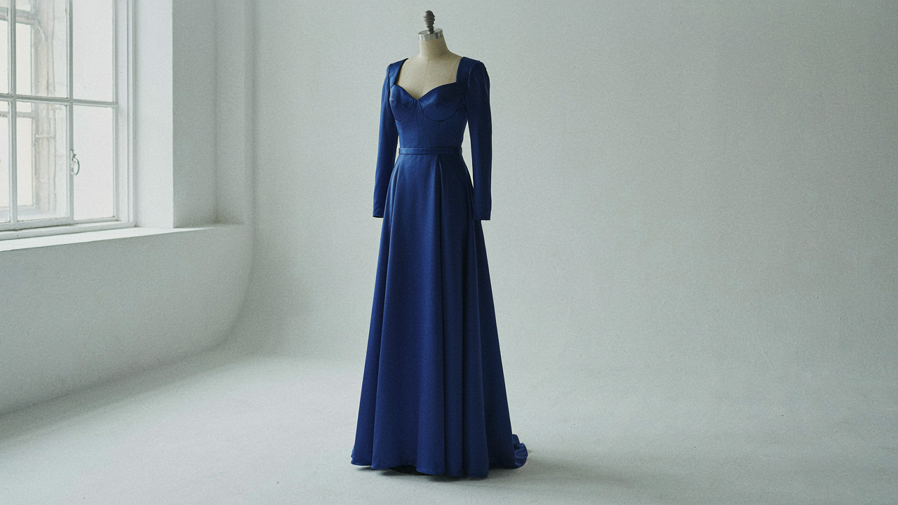 An elegant, structured blue wedding guest dress for large bust is displayed on a mannequin.