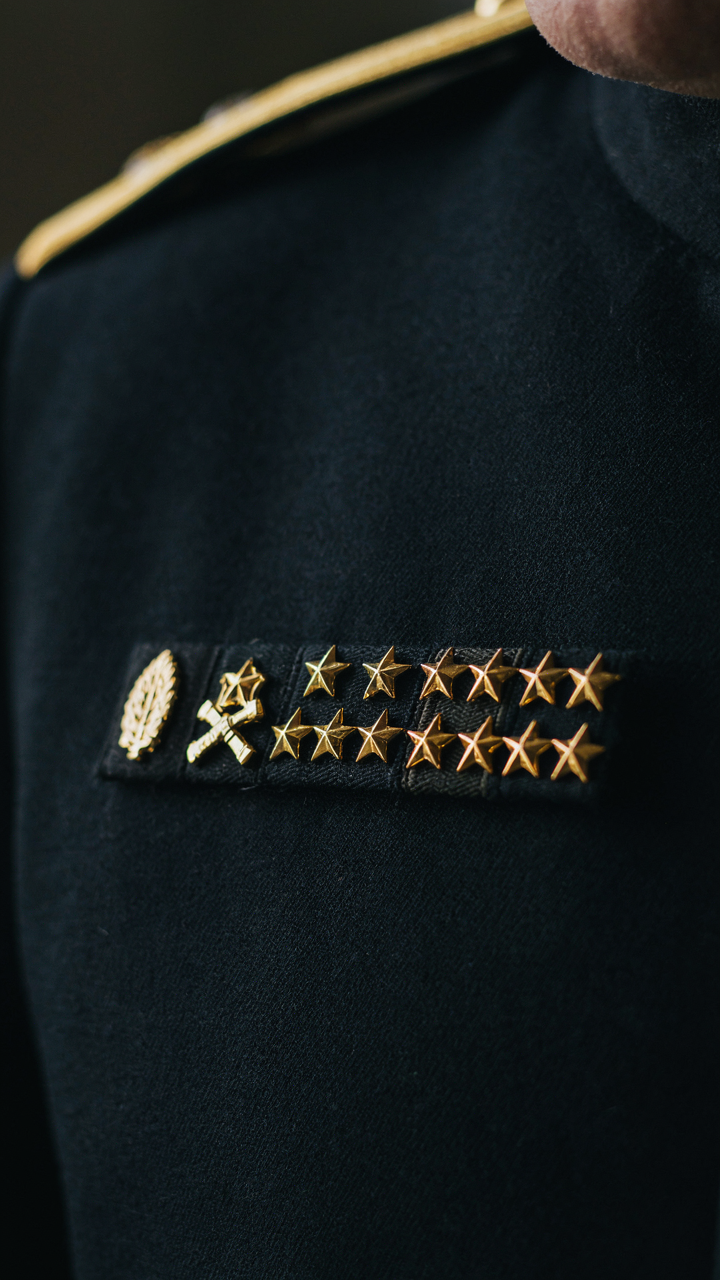 Military rank insignia badges on a uniform, showing hierarchy and status.