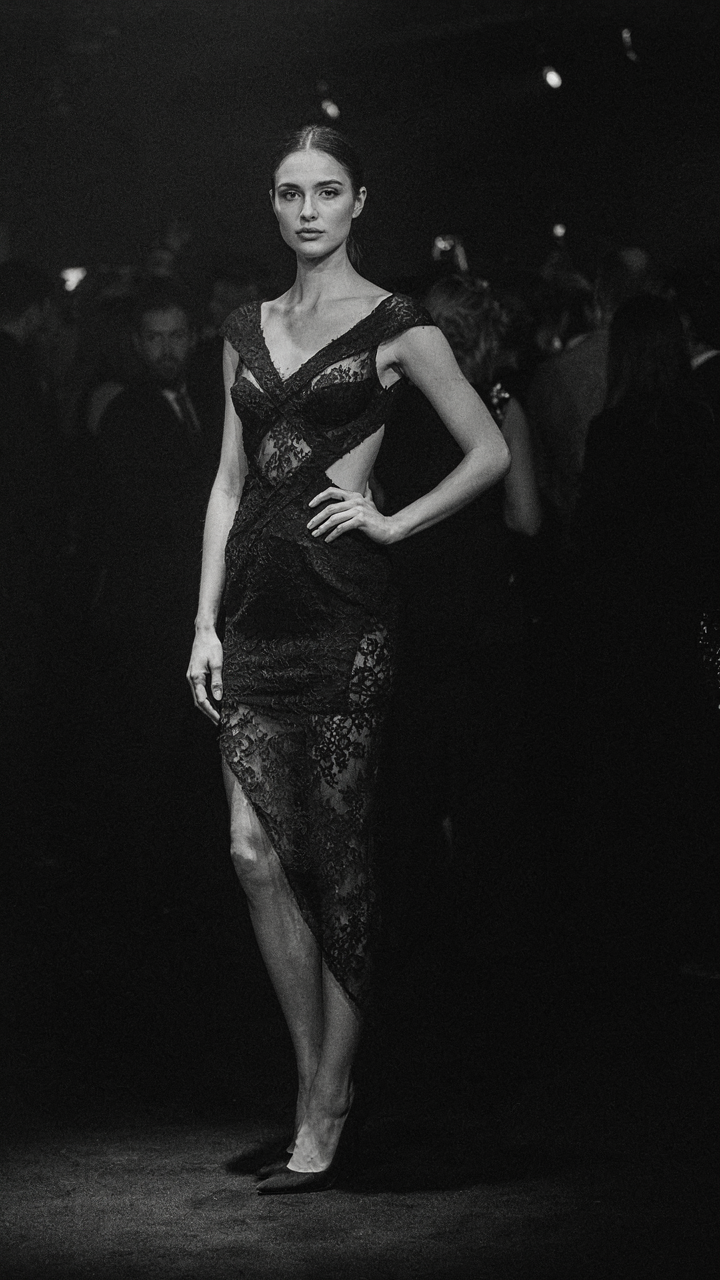 Black lace cocktail dress with asymmetrical hem and architectural design stands out.