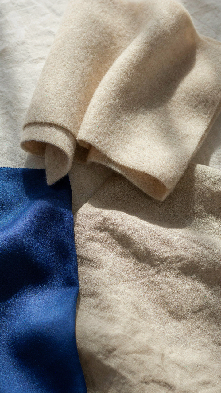 Swatches of merino wool, polyester, and cotton fabrics are shown side-by-side.