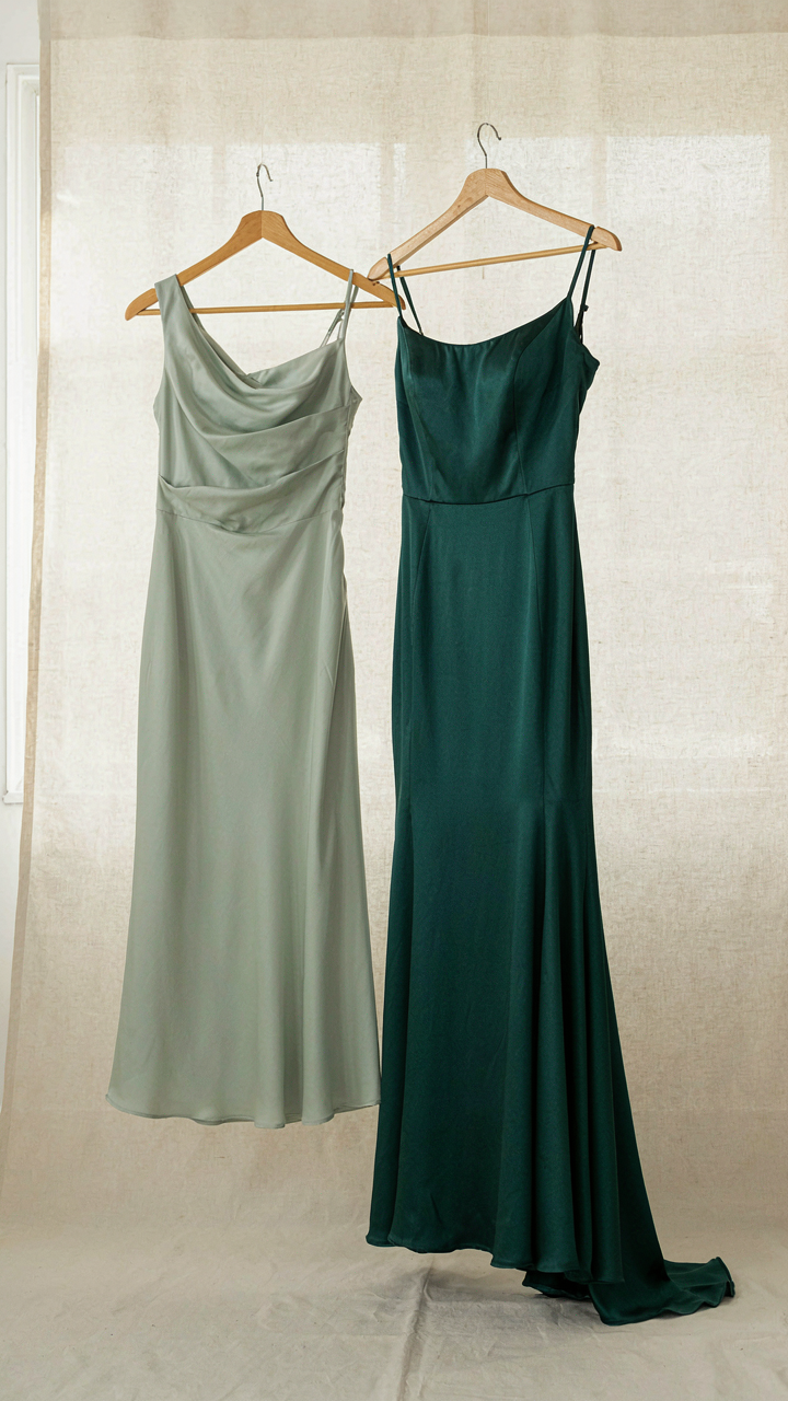 A midi dress hangs next to a floor-length evening gown.