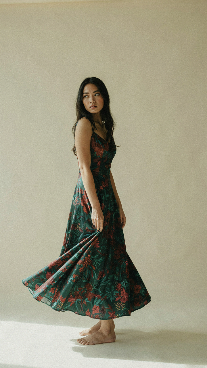 A beautiful silk floral cocktail dress drapes smoothly, showing its soft feel.