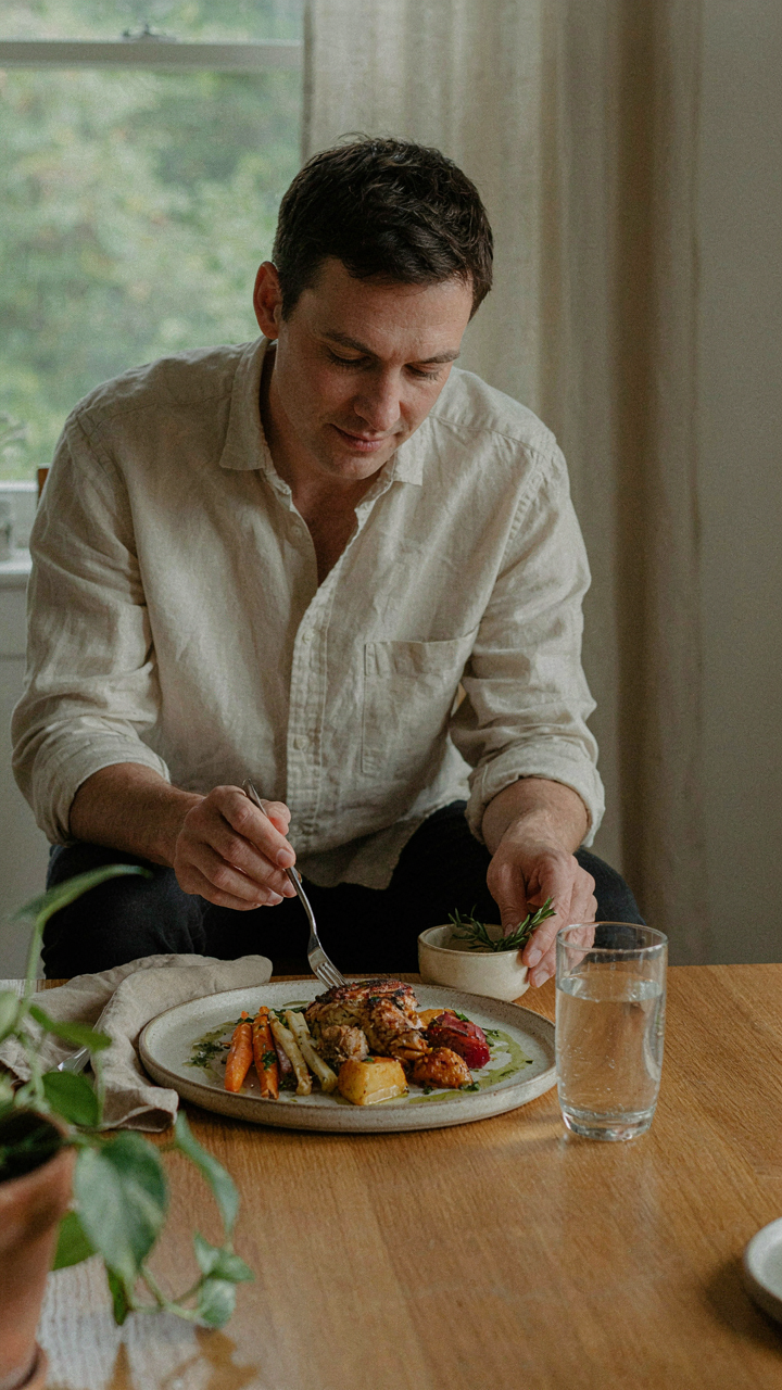 A person in a comfortable linen shirt enjoys a meal.